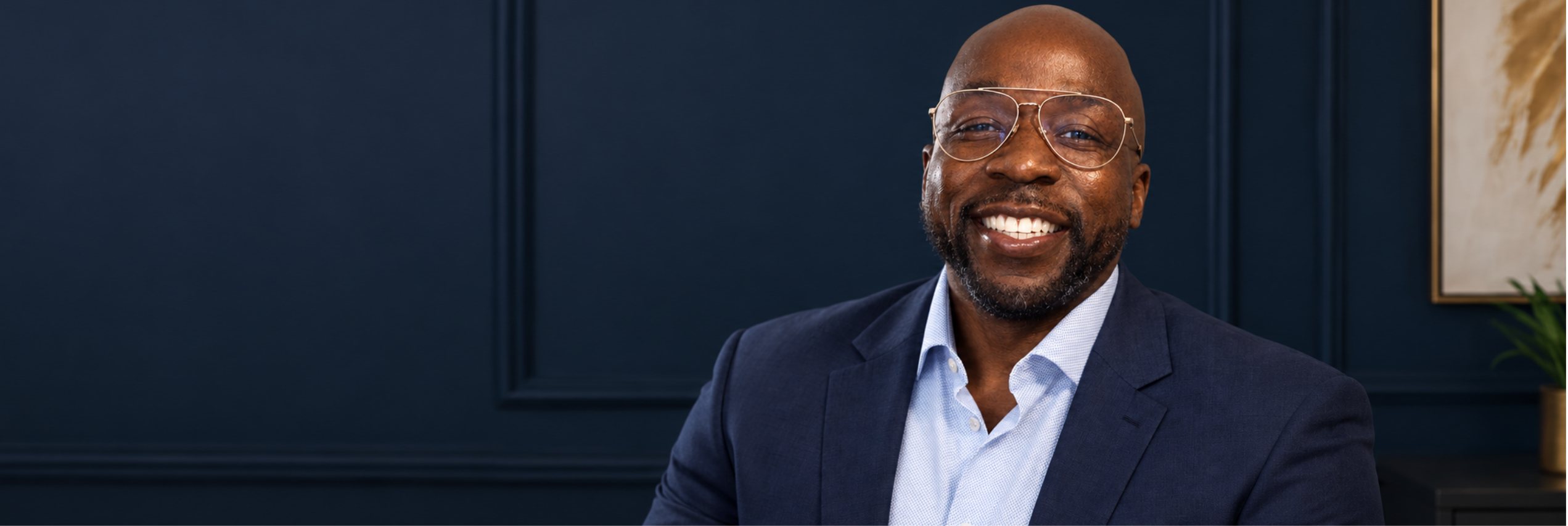 Renel Chantes Domond smiling, in a navy blazer